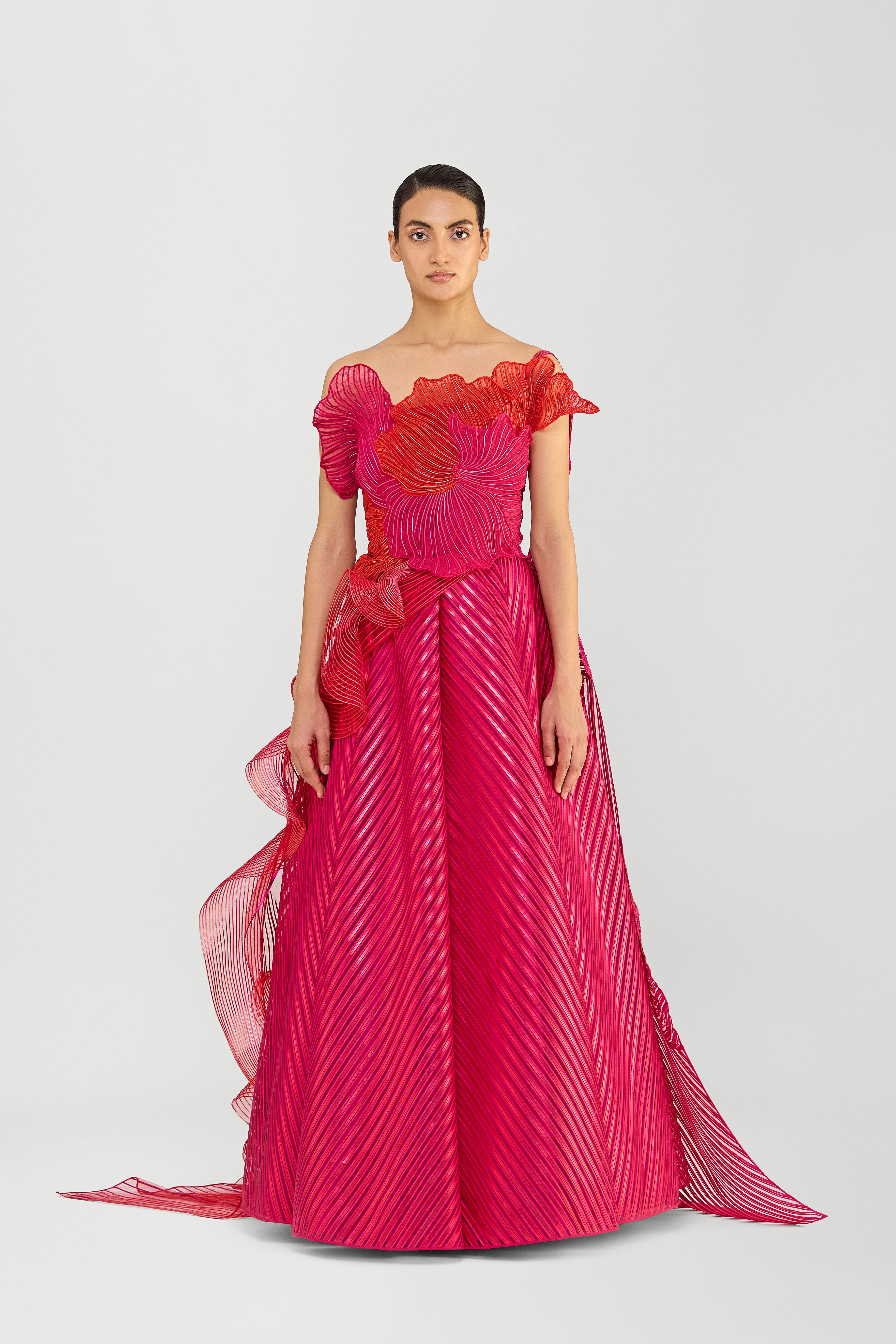 STRUCTURED CORDED CORAL OFF THE SHOULDER GOWN WITH A METALLIC FLUTED TULLE SKIRT AND TWO DRAPES